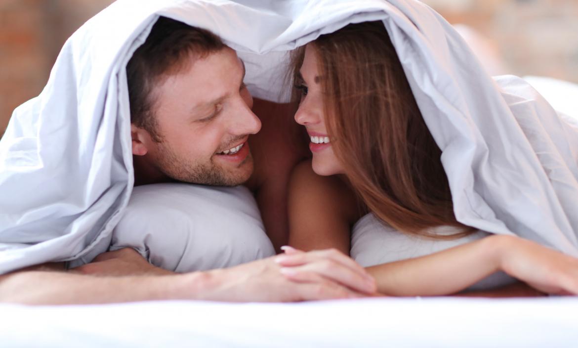 lovely-couple-in-bed-under-the-covers