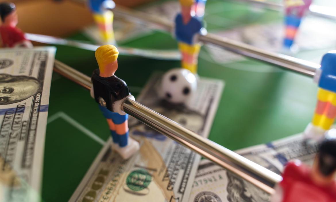 table-football-game-with-us-dollar-bills-scattered-2023-11-27-05-09-44-utc