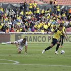 Tomás Rincón (i), capitán de Venezuela, quedó en el suelo tras intentar marcar a Jeremy Sarmiento de Ecuador.