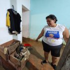 Beatriz Amaguaña revisa parte de la ropa que pudo rescatar de entre el lodo, para ver qué le puede servir todavía.