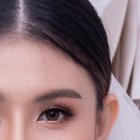 Asian young woman bride trying on wedding dress at modern wedding