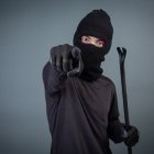 Black criminals wore a head yarn on a gray background.