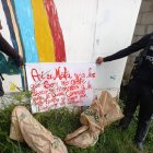 Este papel escrito con marcador rojo y dos sacos de yute fueron hallados junto a la pared de un plantel educativo.