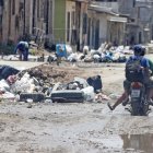 Los conductores y transeúntes deben sortear los baches llenos de agua y los ‘cerros’ de basura.