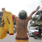 Don Isidro tiene encima importantes símbolos para él: el tatuaje del escudo de Barcelona (en la cabeza), y el de san Jacinto (en la espalda). También tiene la camiseta de