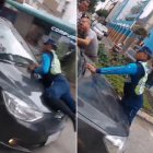 Agente de la ATM tratando de impedir que un supuesto infractor se escape.