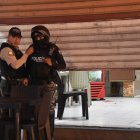 Dos policías custodían el acceso al lugar donde acribillaron a un abogado, mientras comía junto a un amigo.