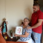Madre e hijo miran el retrato de Cristina embarazada semanas antes del crimen.