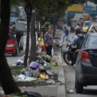 Personas intentando cruzar en medio de una fila de desechos en el parterre de la Av. Modesto Luque.