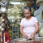 Ella estaba trenzando paja para un individual. Ese era uno de los pedidos de la semana.