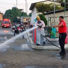 Este viernes 19 de julio, bomberos, con sus motobombas, limpiaban el interior y  exterior de una escuela.