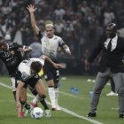 Ángel Romero (c) de Corinthians disputa el balón con Aníbal Chalá (i) de Barcelona en un partido de la tercera ronda de la Copa Libertadores.