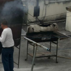 Un hombre quema papeles en la terraza de la Embajada de Cuba en Quito.API