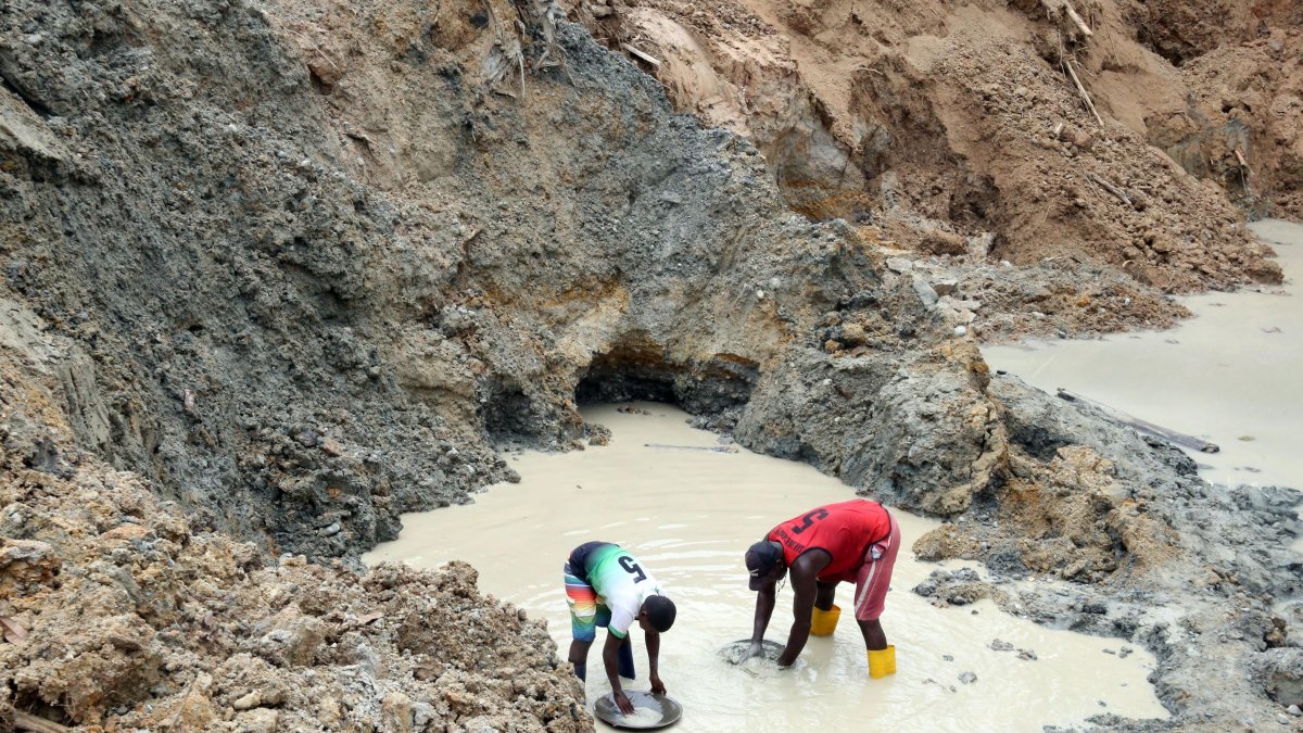 Luis y uno de sus hijos se dedican a lavar el lodo que extraen de la tierra para hallar el oro.
