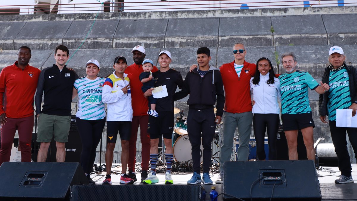 Luis Cárdenas (c) y Mary Granja (d) durante la premiación como ganadores de la octava edición de la carrera Liga 10K.