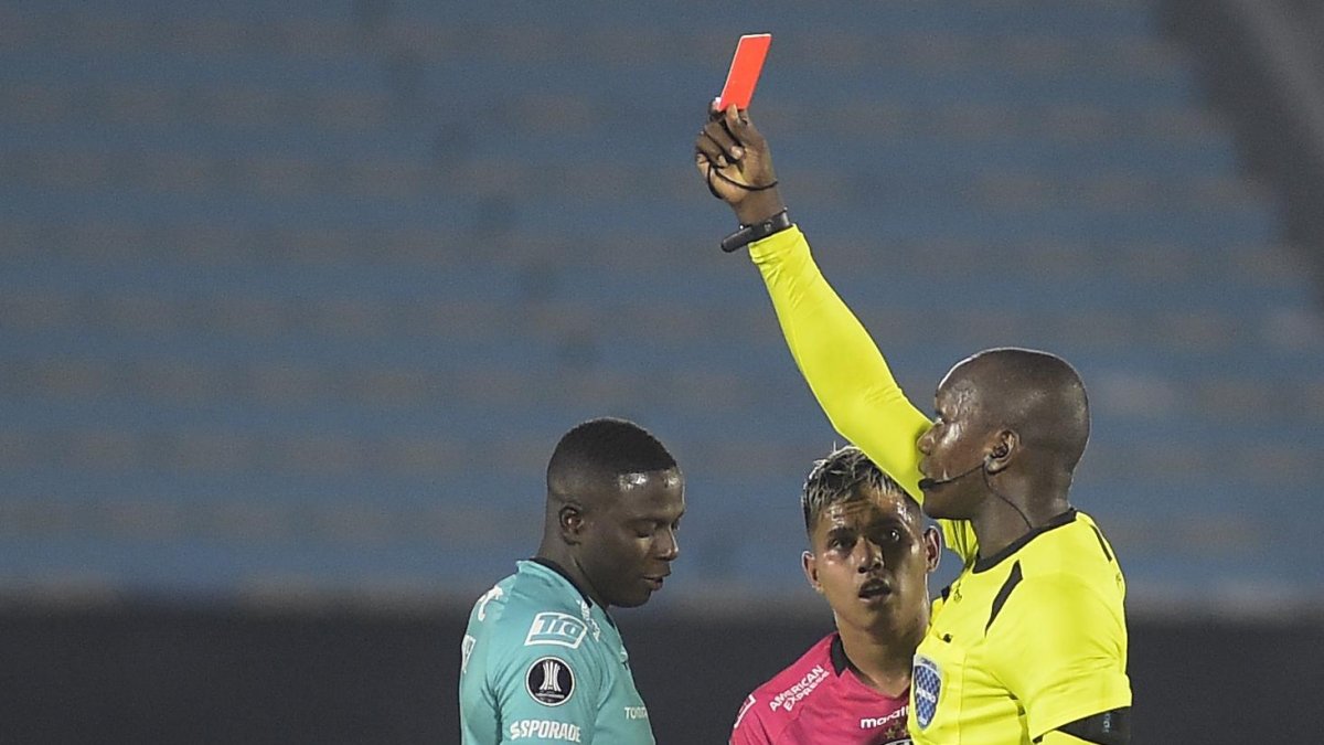El arquero de Independiente del Valle Moisés Ramírez (i) recibe tarjeta roja durante el partido por la fase de grupos de la Libertadores ante el Liverpool FC en el Estadio Centenario en Montevideo.