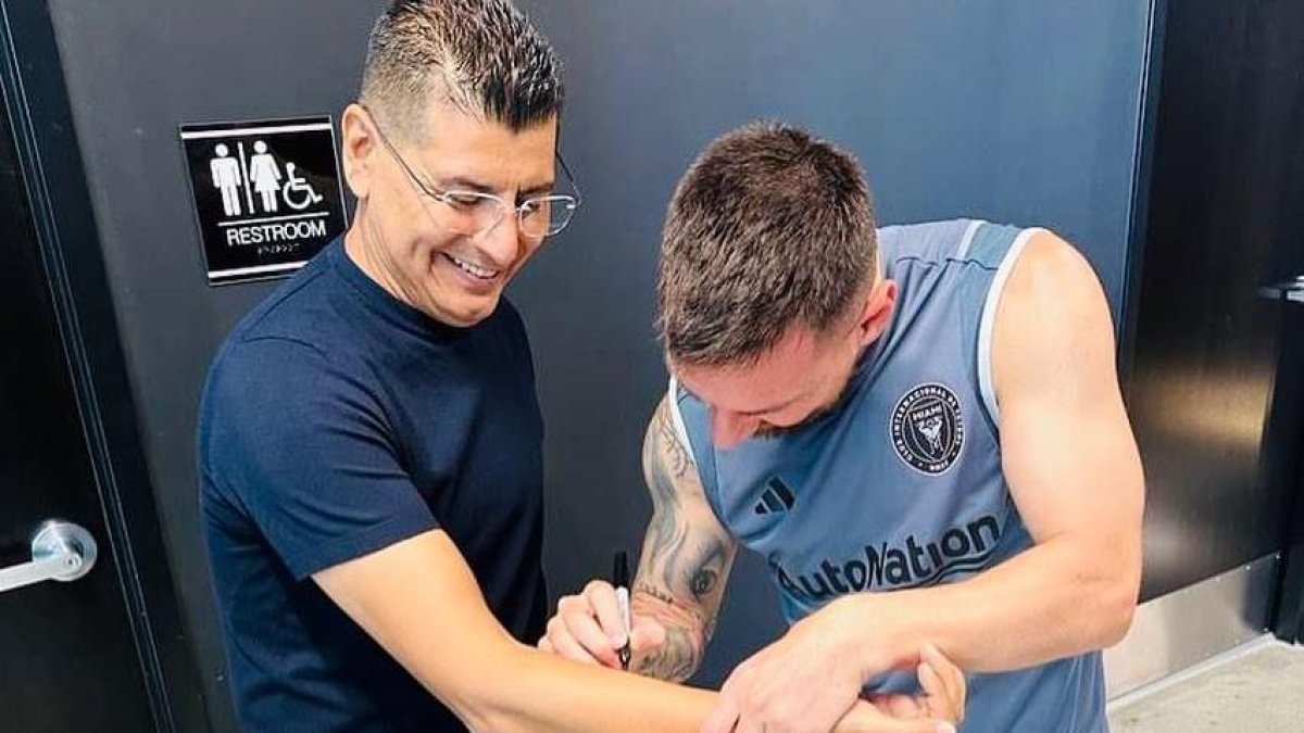 El entrenador y comentarista deportivo José Luis Migueles, recibiendo el autógrafo de Lionel Messi.