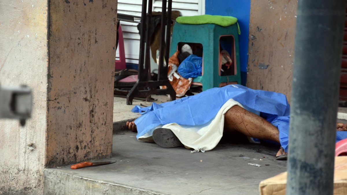 En medio de empujones y hermetismo de la Policía Nacional, los agentes de Criminalística levantaron el arma homicida y llevaron el cuerpo a la morgue.