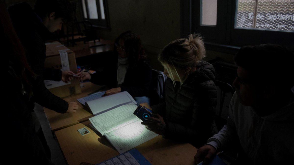 En medio del apagón, ciudadanos asisten a votar en las elecciones de gobernador de la provincia de Santa Fe, este domingo en Rosario, Argentina.