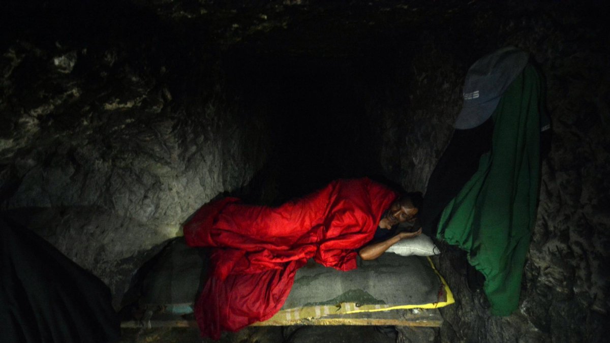 Luis duerme en la cama que construyó dentro de una cueva.