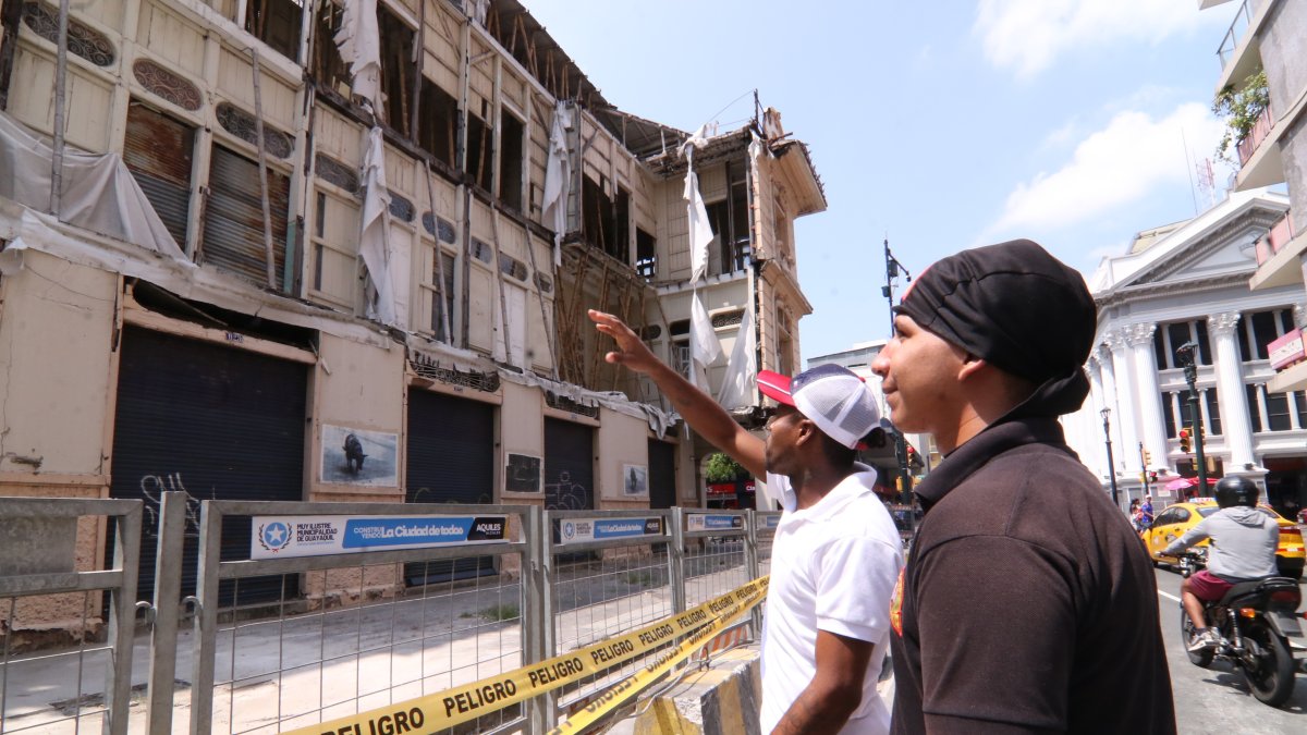 Ciudadanos se detienen a observar el deterioro de la Casa Tola, hoy convertida en un punto de riesgo.