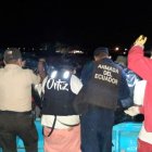 Policías y pescadores desembarcan el cuerpo que fue hallado en altamar, entre las redes de un pescador.