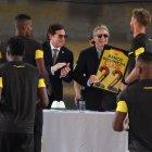 Javier Burrai, estrenando su arete, le entrega la camiseta de Barcelona al presidente Lasso.