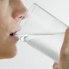 Woman Drinking Glass of Water --- Image by © Royalty-Free/Corbis.