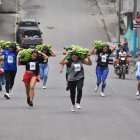 Con racimos de plátano de hasta 20 libras, mujeres y hombres participaron en una carrera.